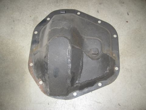 1994 Ford Bronco - A black differential cover sits on a concrete surface.