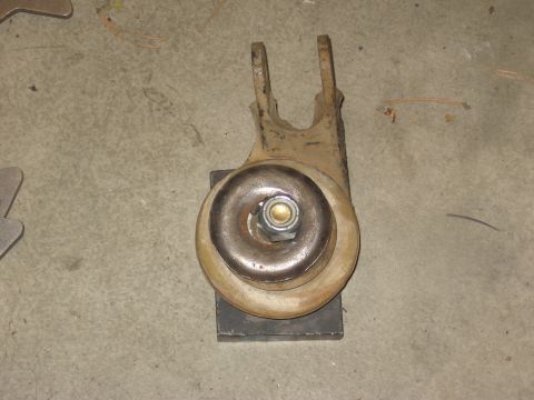 1994 Ford Bronco - A single vehicle suspension part rests on a concrete surface.