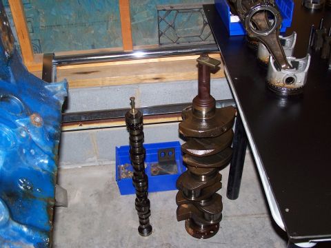 1974 Ford F-100 - Engine components including a crankshaft, camshaft, pistons, and connecting rods are laid out for inspection.