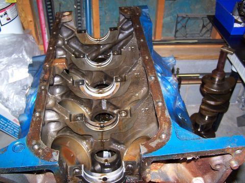 1974 Ford F-100 - Engine block and crankshaft assembly, likely for a V8 engine, in a workshop setting.
