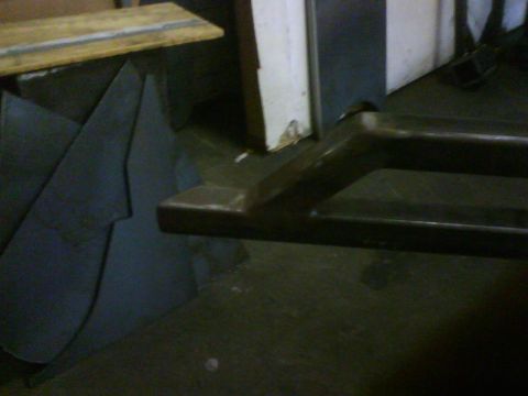 1990 Ford Bronco - A dark metal rock slider is shown in close-up, with a rectangular opening visible.