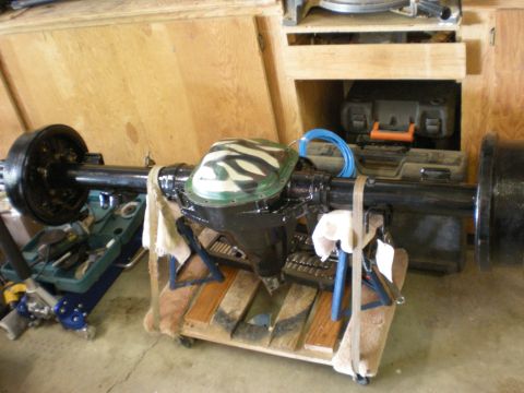 1993 Ford Bronco - Ford Bronco Dana 60 front axle assembly with camouflage differential cover, resting on a wooden dolly.