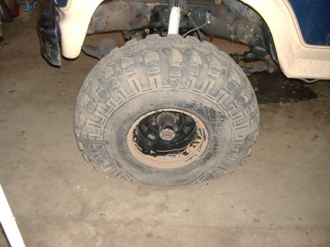 1986 Ford Bronco - The front tire of a 1986 Ford Bronco appears to be flat.