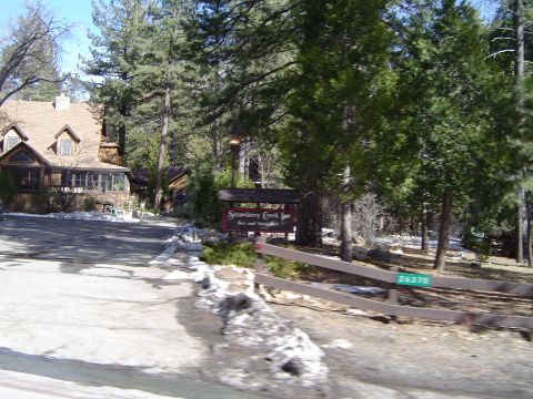 1989 Ford Bronco - A sign for Strawberry Creek Inn is visible in a wooded area with a house nearby.