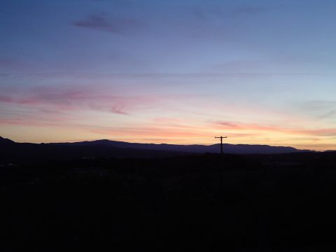1989 Ford Bronco - Sunset sky over mountains with a telephone pole in silhouette.