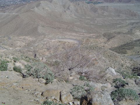 1989 Ford Bronco - A view from a rocky overlook shows a desert landscape with a road winding through the valley below.