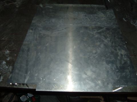 1998 BMW R1100GS ABS - A flat piece of metal is shown on a dark surface, with some scuff marks and reflections.