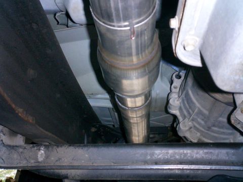 1996 Ford Bronco - Close-up of vehicle's exhaust system and transmission housing.