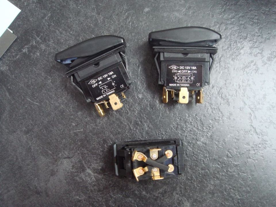 Three automotive rocker switches, two with labels indicating DC 12V 16A and made in Taiwan