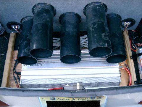 1986 Ford Taurus - Custom car audio installation in the trunk, subwoofers and an amplifier.
