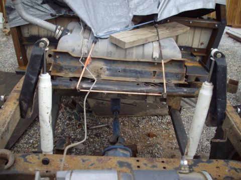 1982 Toyota 4Runner - Rear suspension and fuel tank assembly on a vehicle chassis, undergoing work.