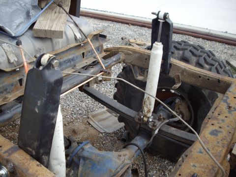 1982 Toyota 4Runner - The rear suspension and frame of a vehicle are shown, with visible rust and some aftermarket parts.