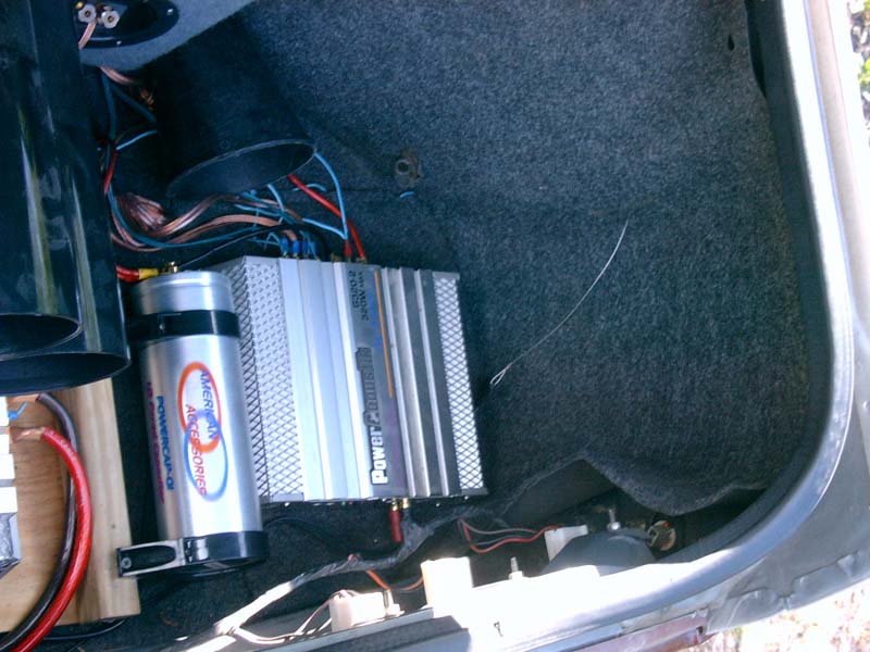 Car audio amplifier and capacitor installed in trunk with wiring