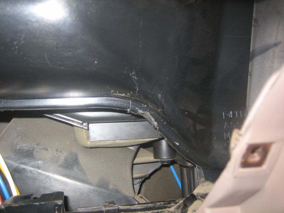 Interior view of vehicle ductwork with wiring and a metal component