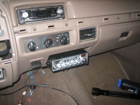 1995 Ford Bronco - Interior shot of a tan Ford truck dashboard showing an aftermarket Sony MOSFET 50Wx4 CD head unit in the upper dash, the factory rotary HVA…