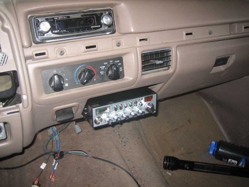 Tan truck dash with aftermarket CD player and under-dash CB radio