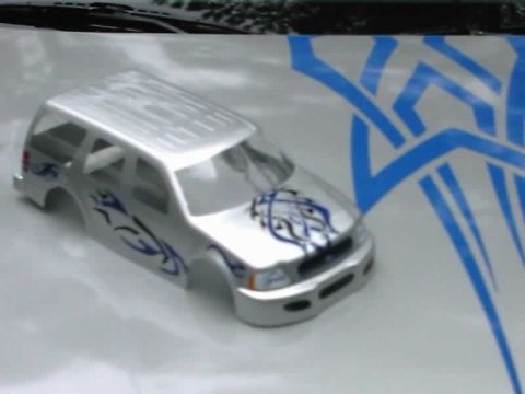 1986 Ford Taurus - This is a silver SUV body with blue tribal graphics, shown from a 3/4 front view.