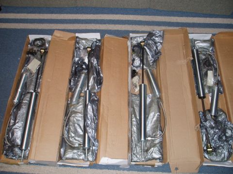 1980 Ford Bronco - Four new Pro Comp Reservoir Shocks are shown in their original packaging, ready for installation.