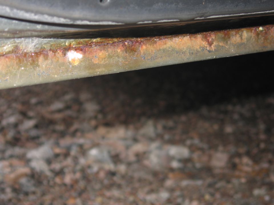 Rusted rocker panel on a 2001 Ford Crown Victoria