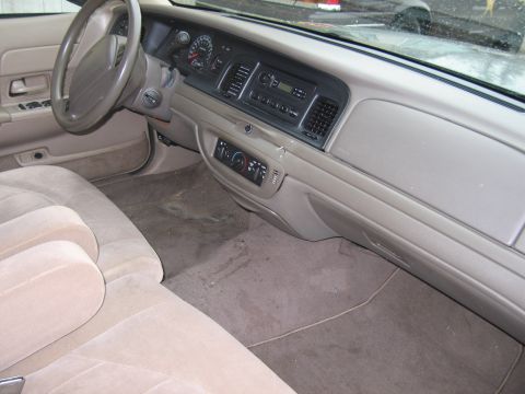 2001 Ford Crown Victoria - The interior of a 2001 Ford Crown Victoria is shown, the driver's side dashboard and front seating area.