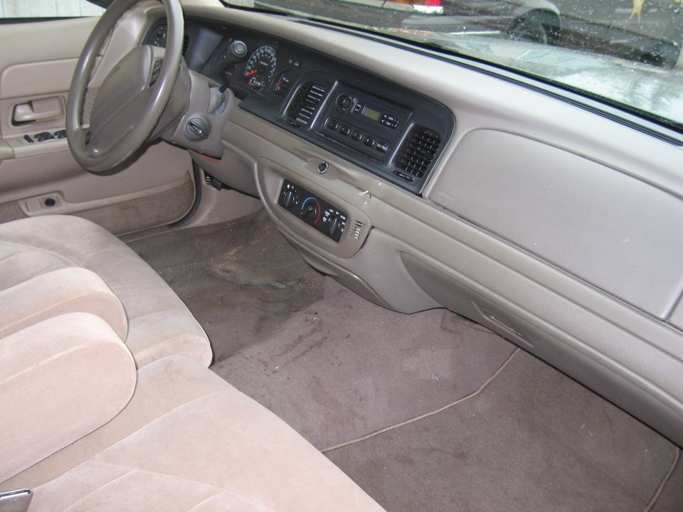 Interior view of a 2001 Ford Crown Victoria, showing the dashboard, steering wheel, and front seats