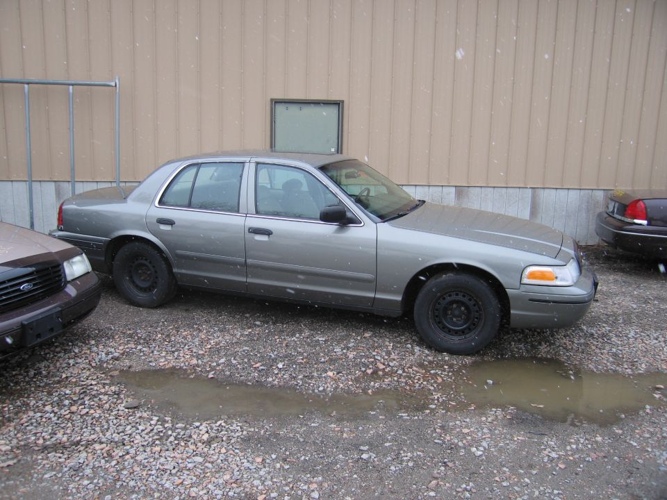 Gray 2001 Ford Crown Victoria sedan, side view, parked outdoors
