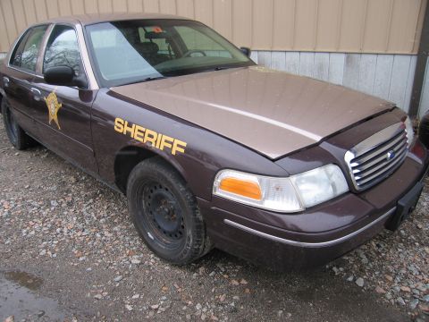 2001 Ford Crown Victoria - This 2001 Ford Crown Victoria Sheriff's car is parked outdoors on a gravel lot.