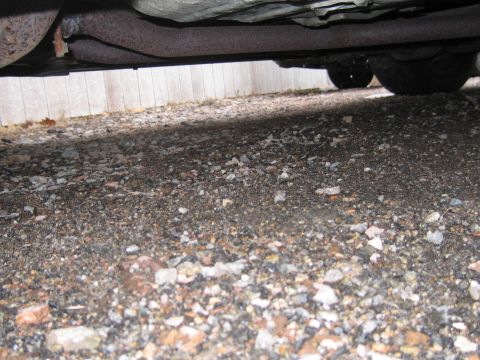 2001 Ford Crown Victoria - The underside of a vehicle, showing the exhaust system and part of the rear tire.