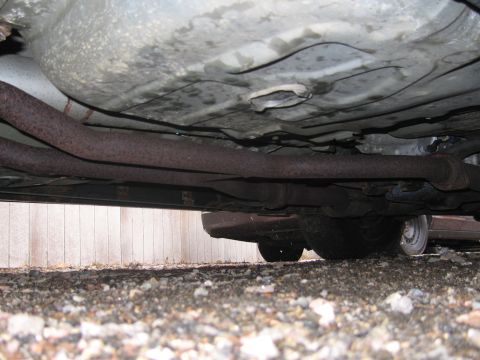 2001 Ford Crown Victoria - Underside view of a car, focusing on the exhaust system and tires.