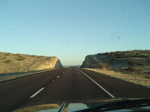 1989 Ford Bronco - Driving on a highway through a rocky landscape during the day.