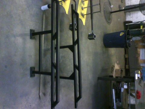 1990 Ford Bronco - These rock sliders are mounted on a wall in what appears to be a garage or workshop.