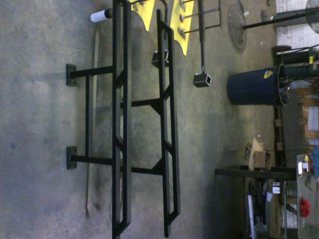 Pair of black metal rock sliders mounted on a wall