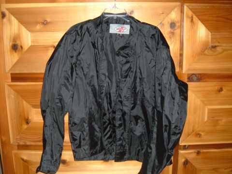 1998 BMW R1100GS ABS - A black Joe Rocket motorcycle jacket is displayed against a wooden background.