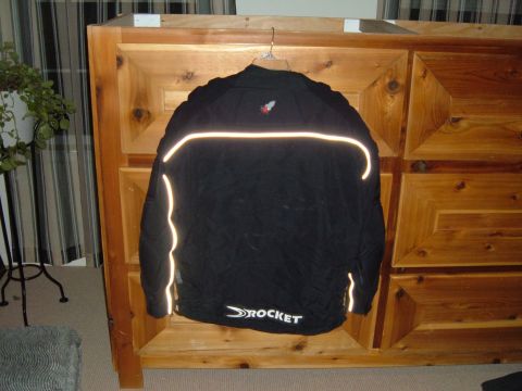 1998 BMW R1100GS ABS - A black motorcycle jacket with reflective accents and a prominent 'ROCKET' logo is displayed.