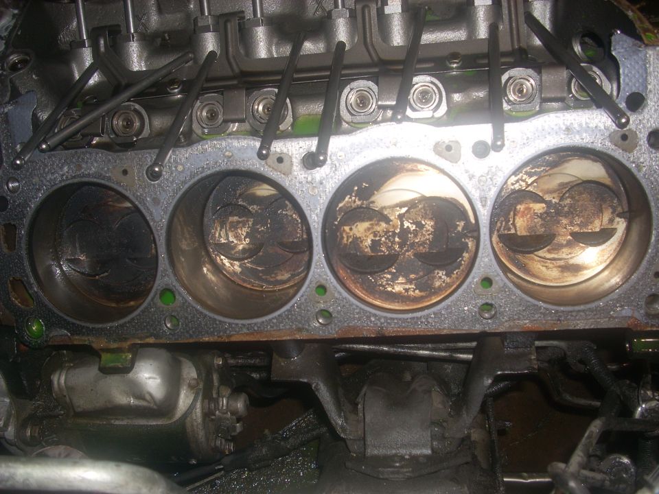 Engine cylinders with carbon buildup and visible pistons