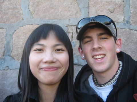 1996 Ford Bronco - A young couple poses for a selfie in front of a textured stone wall.