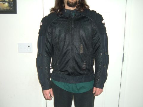 1998 BMW R1100GS ABS - A person stands indoors wearing a black motorcycle jacket with mesh panels and protective padding.