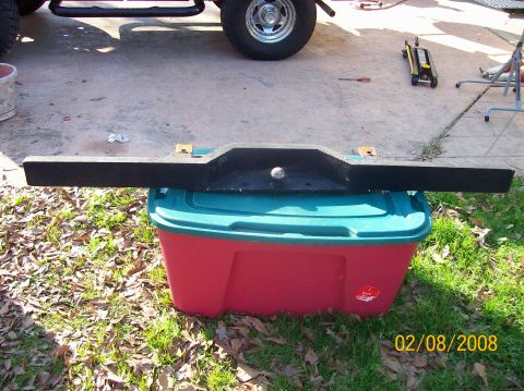 1973 Ford Bronco - A black bumper part rests on a storage bin, with a Supermotors watermark and date visible.