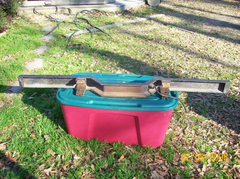 1973 Ford Bronco - Front bumper assembly for a 1973 Ford Bronco, resting on a storage bin outdoors.