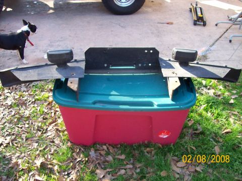 1973 Ford Bronco - A front bumper assembly with integrated lights is displayed on a plastic storage bin outdoors.