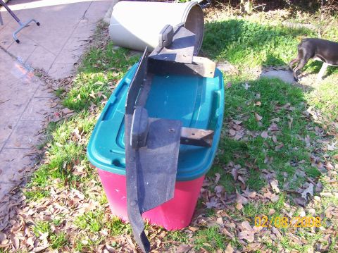 1973 Ford Bronco - Car bumper part sits on a storage bin with a dog in the background.