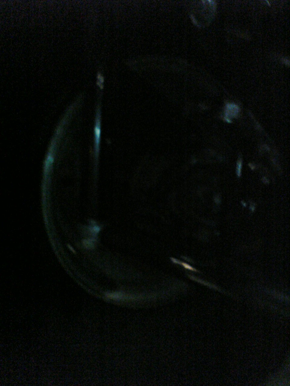 Headlight lens with internal reflection, dark background