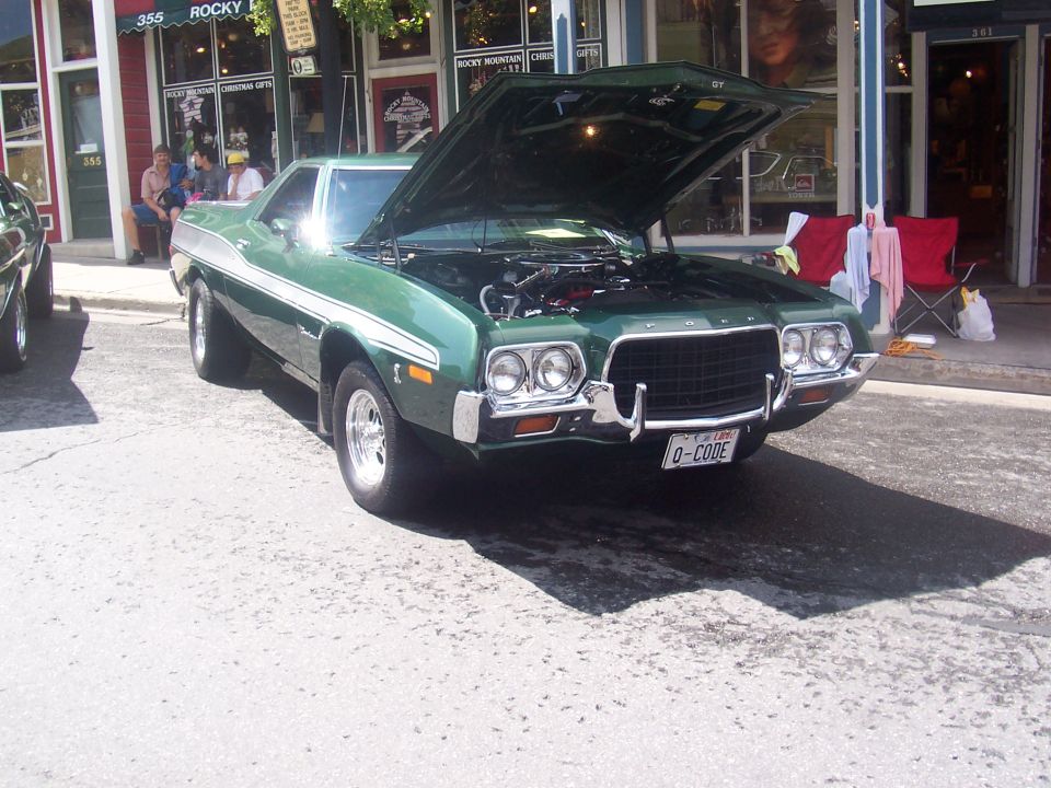 Green 1972 Ford Ranchero with hood open, showing engine
