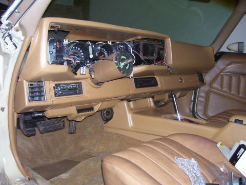 1979 Chevrolet Camaro - The interior of a 1979 Chevrolet Camaro shows a disassembled dashboard with exposed wiring and gauges.