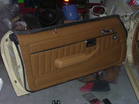 1979 Chevrolet Camaro - Interior door panel with tan upholstery and a prominent armrest, viewed from the side.