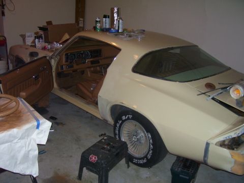 1979 Chevrolet Camaro - A beige 1978 Chevrolet Camaro is parked inside a garage with its driver's door open, showing the tan interior.