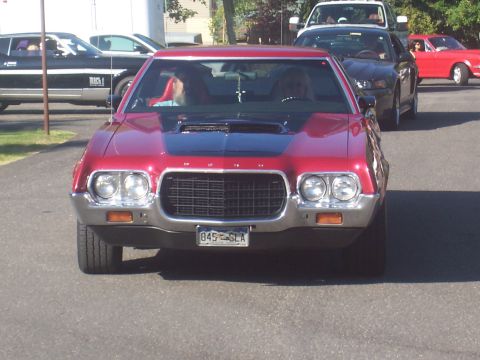 1973 Ford Mustang - Front view of a red 1972 Ford Gran Torino Sport in a line of cars.