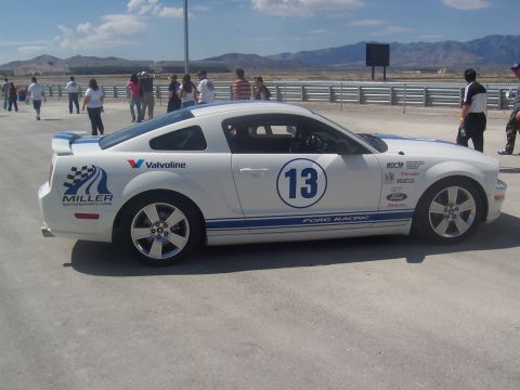 1973 Ford Mustang - This white Ford Mustang, adorned with blue racing stripes and the number 13, is captured in a front three-quarter view at what appears to b…