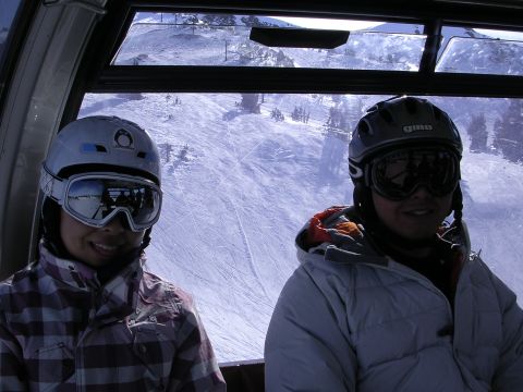 1983 Ferrari Enzo - Two individuals ride a ski lift, with a snow-covered mountain and ski slopes visible through the window.