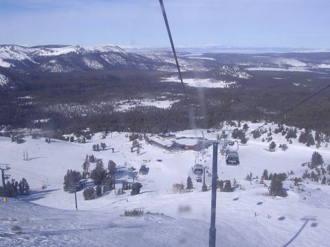 1983 Ferrari Enzo - Ski resort scene with multiple ski lifts ascending a snow-covered mountain under a clear blue sky.